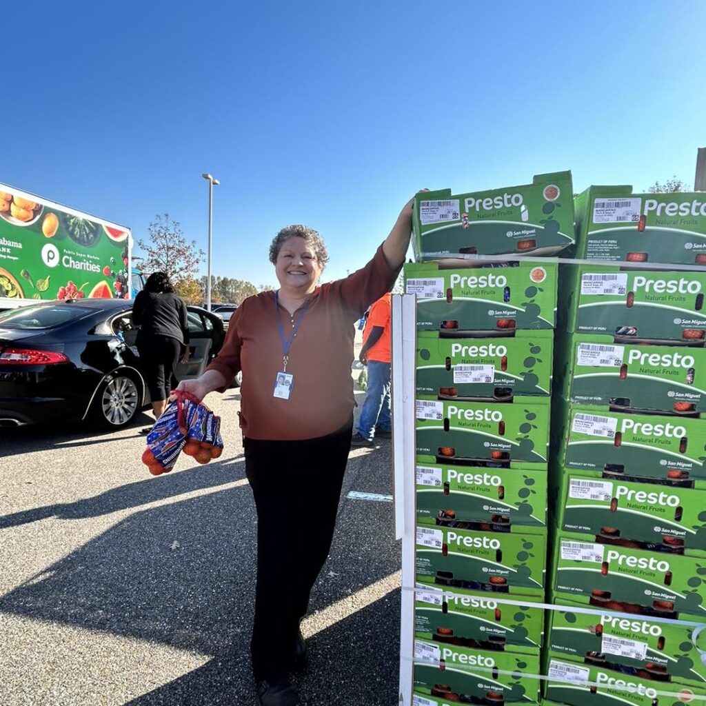 a woman standing next to a stack of boxes
