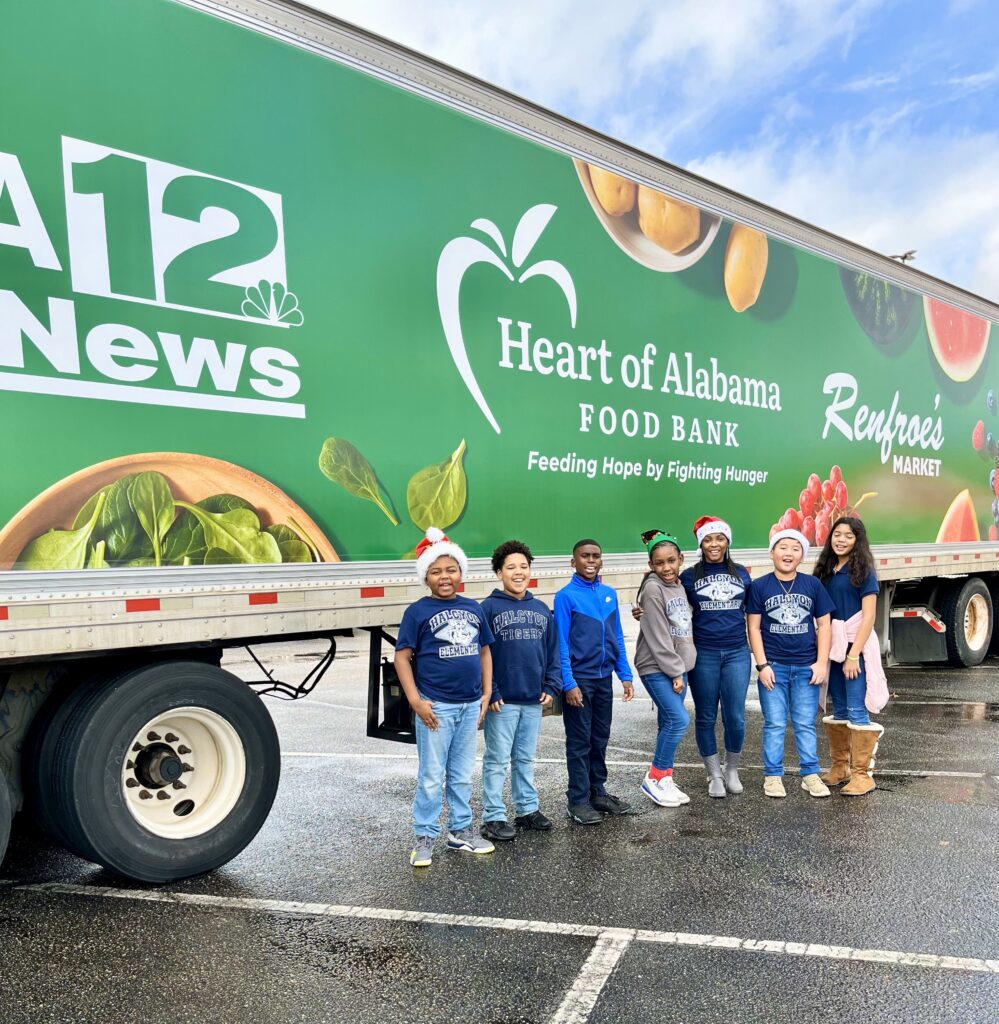 a group of people standing in front of a truck